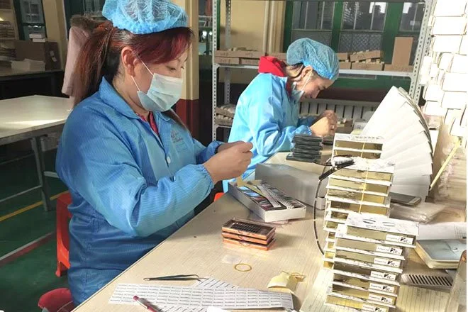 Eyelash trays being assembled for production
